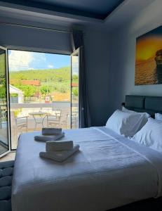 a bedroom with a large bed and a large window at VILLA Konstantinos in Agios Georgios