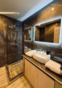 a bathroom with a sink and a shower at VILLA Konstantinos in Agios Georgios +40 photos
