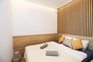 a bedroom with a bed with a book on it at BL Waterside 55 in Balatonlelle