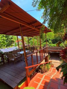 a wooden deck with a picnic table and a pavilion at Casa Bosco Minca in Santa Marta
