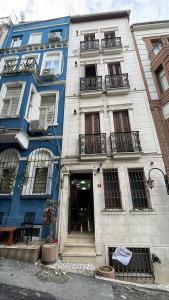 a blue and white building with a door at Taksim Pera Premium Gold Hotel in Istanbul