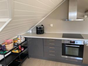 a kitchen with a counter with a sink and a stove at Apartment in beautiful Stange in Stange
