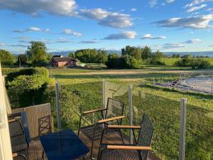 a porch with chairs and a view of a field at Apartment in beautiful Stange in Stange