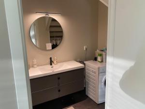 a bathroom with a sink and a mirror at Apartment in beautiful Stange in Stange