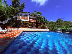a swimming pool in front of a house at Casa Bosco Minca in Santa Marta