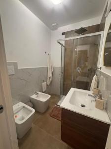 a bathroom with a sink and a shower and a toilet at B&b Al Castello in Gerace
