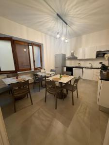 a kitchen with tables and chairs in a room at B&b Al Castello in Gerace