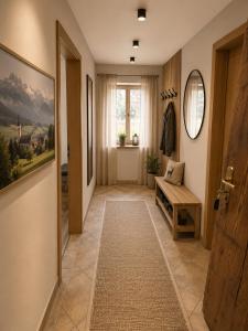a hallway with a bench and a window at Haus Dippel am Kurpark inklusive Chiemgaukarte in Ruhpolding