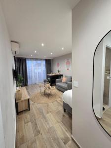 a room with a bed and a living room at Studio cosy devant RER B TGV Massy SNCF in Massy