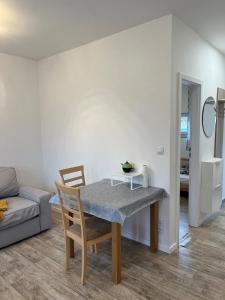 a dining room with a table and a couch at Útulný 1kk byt in Líšnice