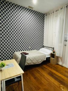 a small room with two beds and a table at M-Room in Málaga +6 photos