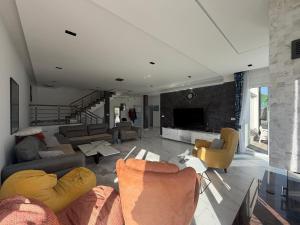 a large living room with couches and a tv at Villa Berisha in Mazgit