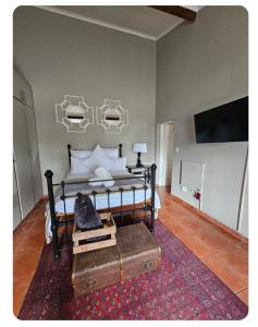 a bedroom with a bed with a table and a tv at StayAtGoethe in Secunda