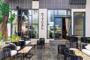 a cafe with tables and chairs in front of a building at Solaris Luxury Residence Osu Pool Gym in Accra