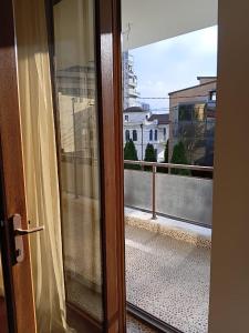 a door to a balcony with a view of a building at Dream House Hostel & Hotel in Yerevan