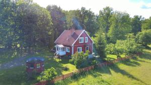 an aerial view of a red house in a field at Hus Hornsö in Blomstermåla