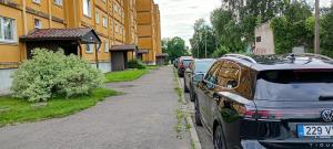 eine Reihe von Autos, die am Straßenrand geparkt sind in der Unterkunft Michael Apartment in Valga