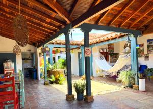 an outdoor patio with hammocks on a house at Hostel Trip Monkey Barichara in Barichara
