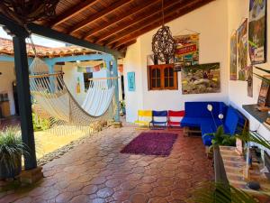 a living room with two hammocks in a house at Hostel Trip Monkey Barichara in Barichara