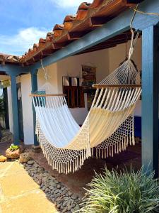 a hammock hanging outside of a house at Hostel Trip Monkey Barichara in Barichara