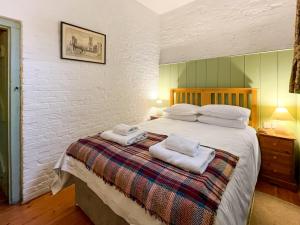 a bedroom with a large bed with towels on it at Stables - Uk51018 in Louth