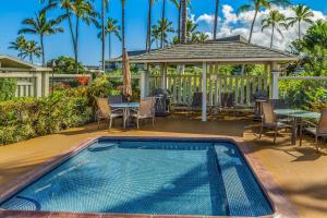 a swimming pool in a yard with a table and chairs at Alii Kai II 10A in Princeville