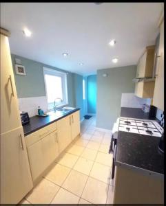 a kitchen with a sink and a stove at Anghorfa in Llanberis
