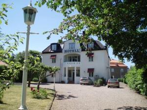 
a white house with a large window at Hotell S:t Olof in Falköping
