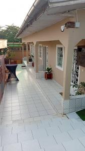 a house with a tile floor and a patio at Côté Plage Kribi Studio Soleil in Kribi