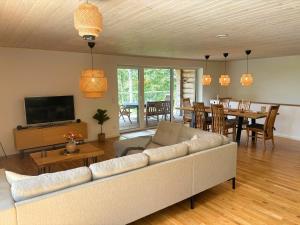 a living room with a couch and a dining room at Villa Bergsmåla in Eringsboda