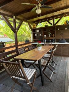 a wooden table and chairs on a patio at Harmat Apartman Hajdúnánás in Hajdúnánás