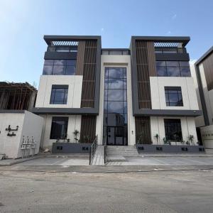 a large white building with a lot of windows at Atrah Quiet Stylish Studio in Medina