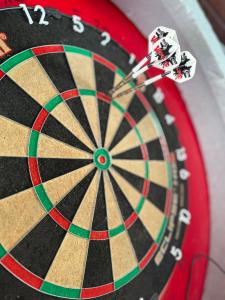 a dart board with darts in the middle at Harmat Apartman Hajdúnánás in Hajdúnánás