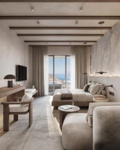 a living room with two beds and a couch at Geomilos Private Suites Milos in Triovasálos