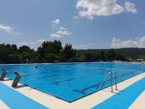 a large swimming pool with people in the water at Flowers Cabin in Valjevo
