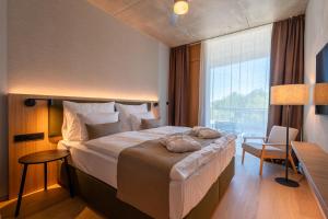 a hotel room with a large bed and a window at ARTEVINI Resort & Winery in Velké Pavlovice +44 photos