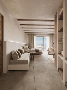 a living room with two couches and a large window at Geomilos Private Suites Milos in Triovasálos +2 photos
