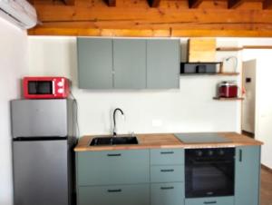 a kitchen with a refrigerator and a sink at Casa LB14 in Castelletto Borgo