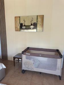 a bed in a room with two pictures on the wall at IGI Apartments in Bogorodica