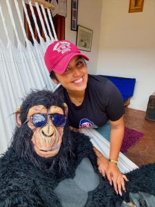 a woman sitting next to a stuffed dog with sunglasses at Hostel Trip Monkey Barichara in Barichara +19 photos