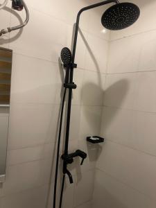 a shower in a bathroom with a shower head at Chase hotels in Ibadan +11 photos