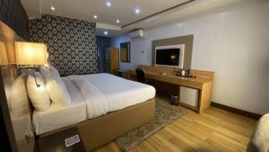 a hotel room with a bed and a desk at Novatel Radisson Lekki in Lekki +24 photos