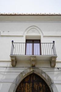 a balcony on top of a building with a door at L'antica Dimora Fronte Mare in Finale