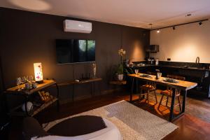 a living room with a table and a kitchen at Cabana Secreta in Petrópolis