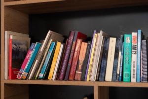 a row of books sitting on a book shelf at Colibri Wasi Pisac in Cusco +27 photos