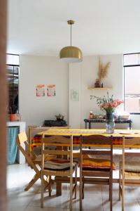 a dining room with a table and chairs at Colibri Wasi Pisac in Cusco