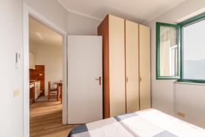 a bedroom with a closet and a bed and a window at Casa Dreamo in Sarnico +16 photos