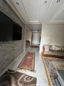 a living room with a flat screen tv on a wall at Safae in Agadir