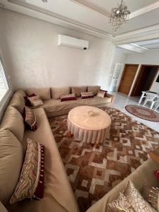 a living room with a couch and a coffee table at Safae in Agadir
