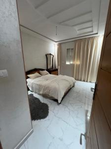 a bedroom with a bed in a room with a mirror at Safae in Agadir